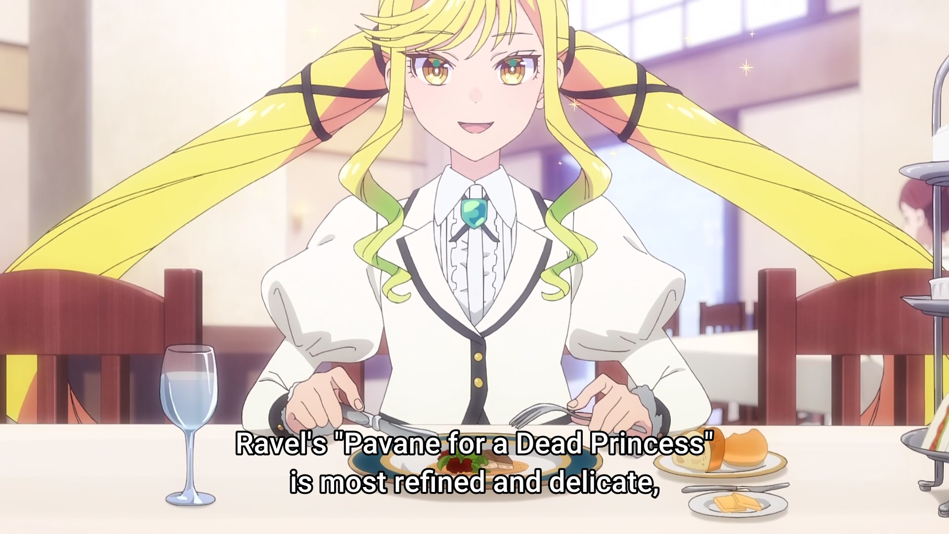 An elegant blond haired young lady pauses in eating her refined meal, knife and fork poised delicately above her plate, to explain what her favourite piece of music is. What she says is that 'Ravel's Pavane for a dead princess is most refined and delicate'. Oh, her twin tails are absurdly huge bows extending at least a metre either side of her head.